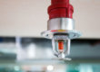a fire sprinkler on a ceiling of a roof
